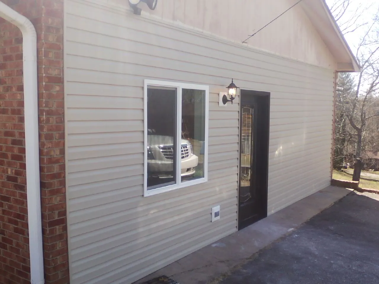 New vinyl siding and entry door on a room addition in Pike Road