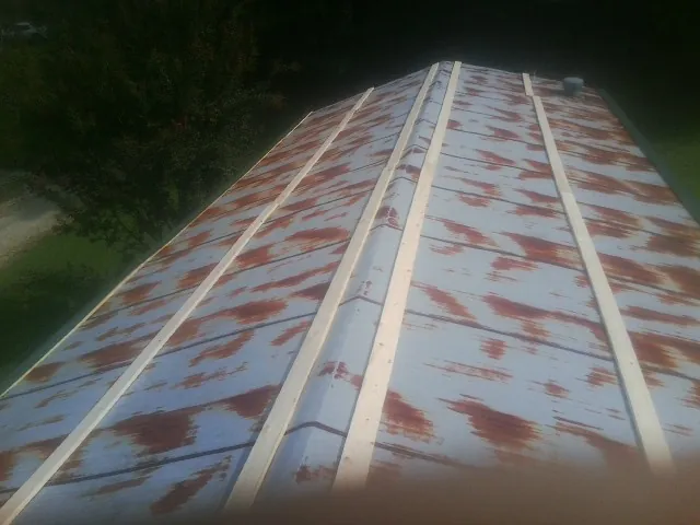 Rusted metal roof panels with new wood purlins before replacement — Storm Damage Roof Repair in Pike Road by Roofing Brothers