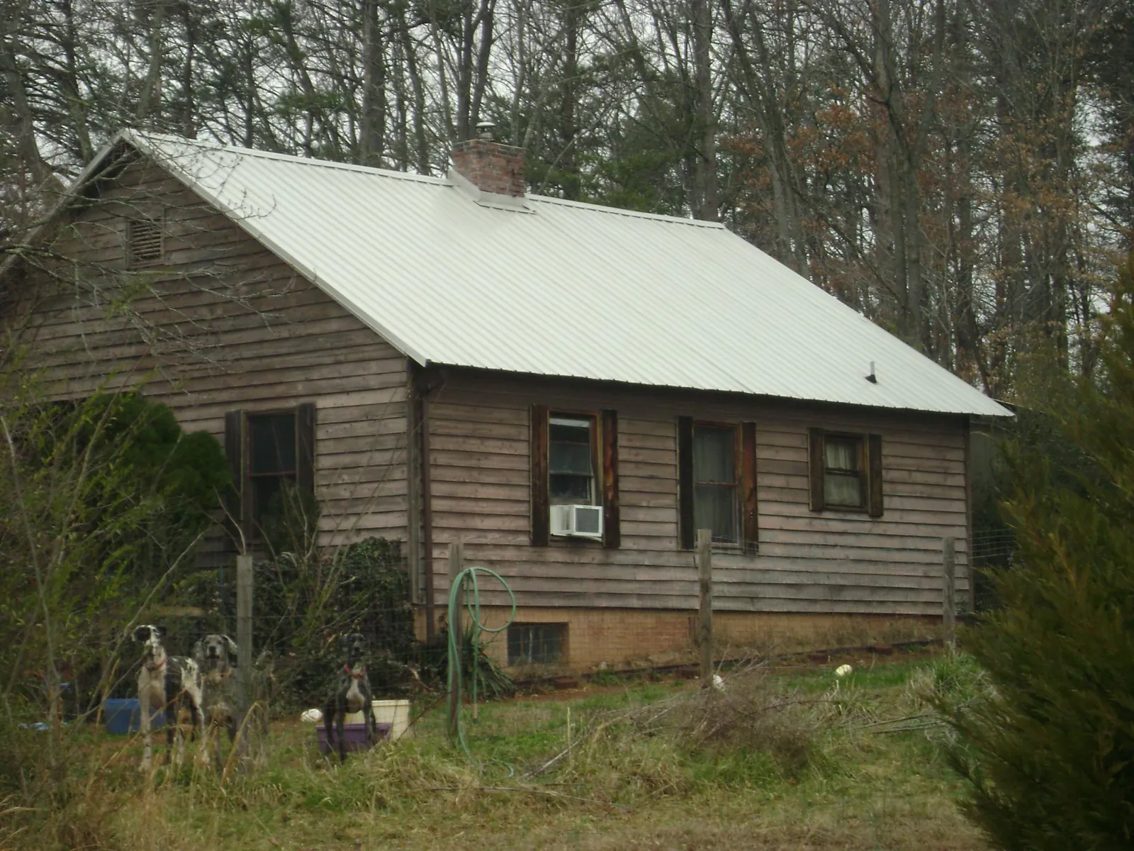 White metal roof on an old wood sided farmhouse, from a Metal Roof Installation job in Pike Road